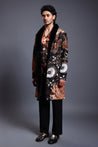 Black overcoat with a striking snake print, featuring mixed media embroidery and a plush faux fur collar.