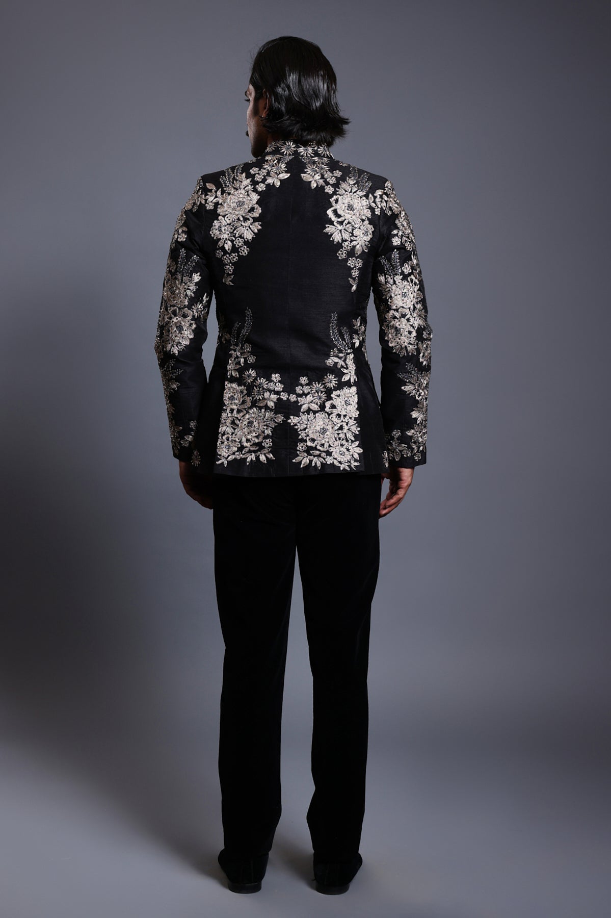 Elegant black velvet bandhgala with rich baroque patterns and subtle crystal highlights, perfect for formal occasions