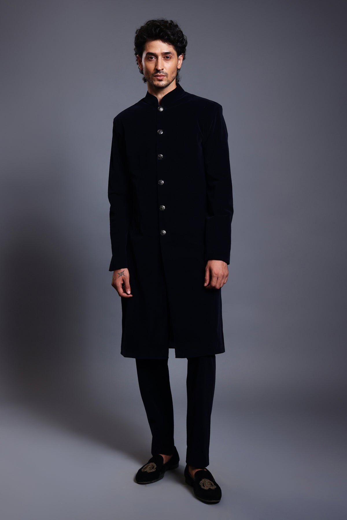 Black velvet sherwani with sleek gunmetal buttons, offering a timeless and sophisticated look.