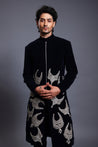 Navy velvet sherwani featuring intricate patchwork necklaces, combining luxury with traditional elegance.