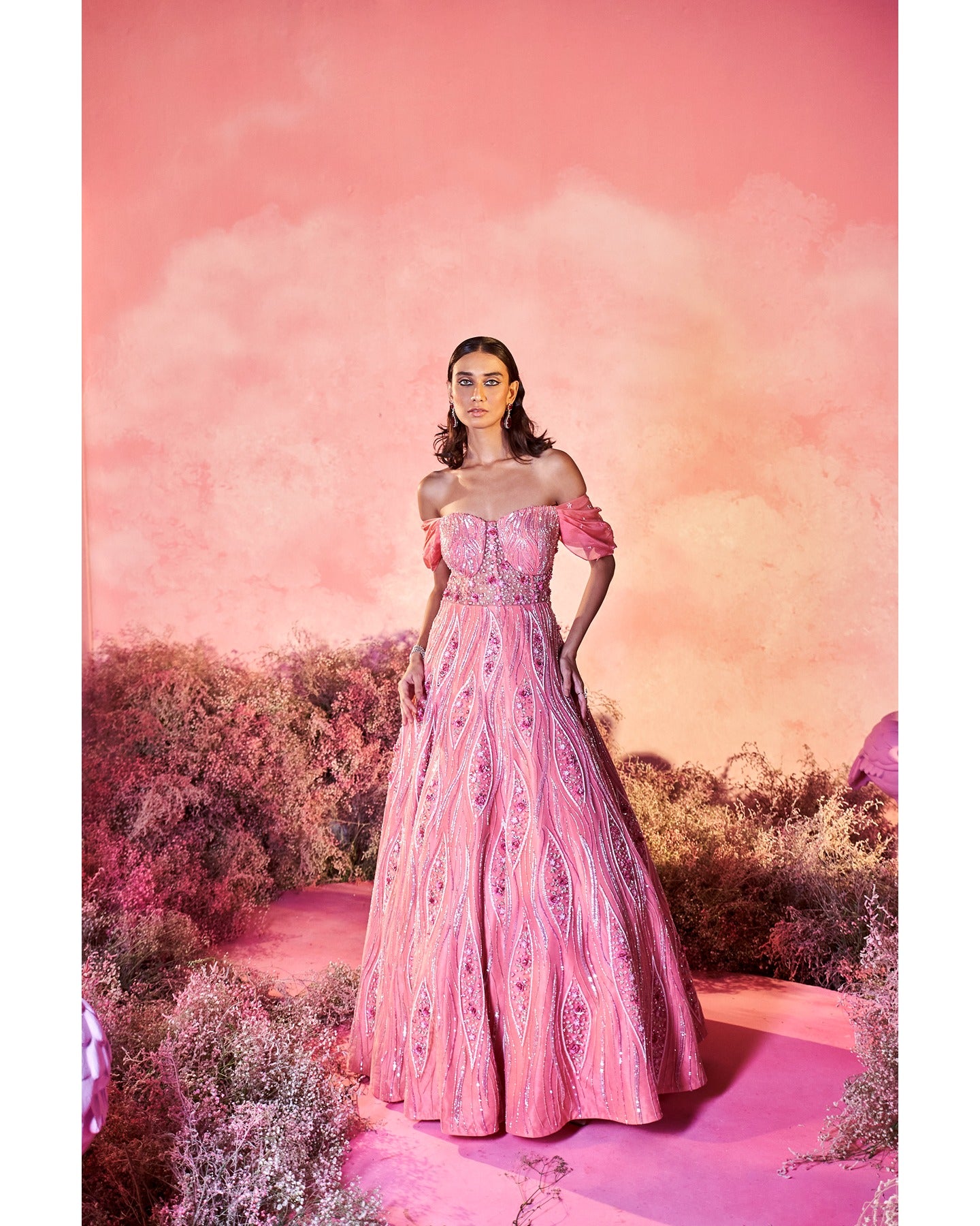 In the spotlight: Dazzling in bright pink, this hand-embroidered gown is a masterpiece of elegance and craftsmanship.