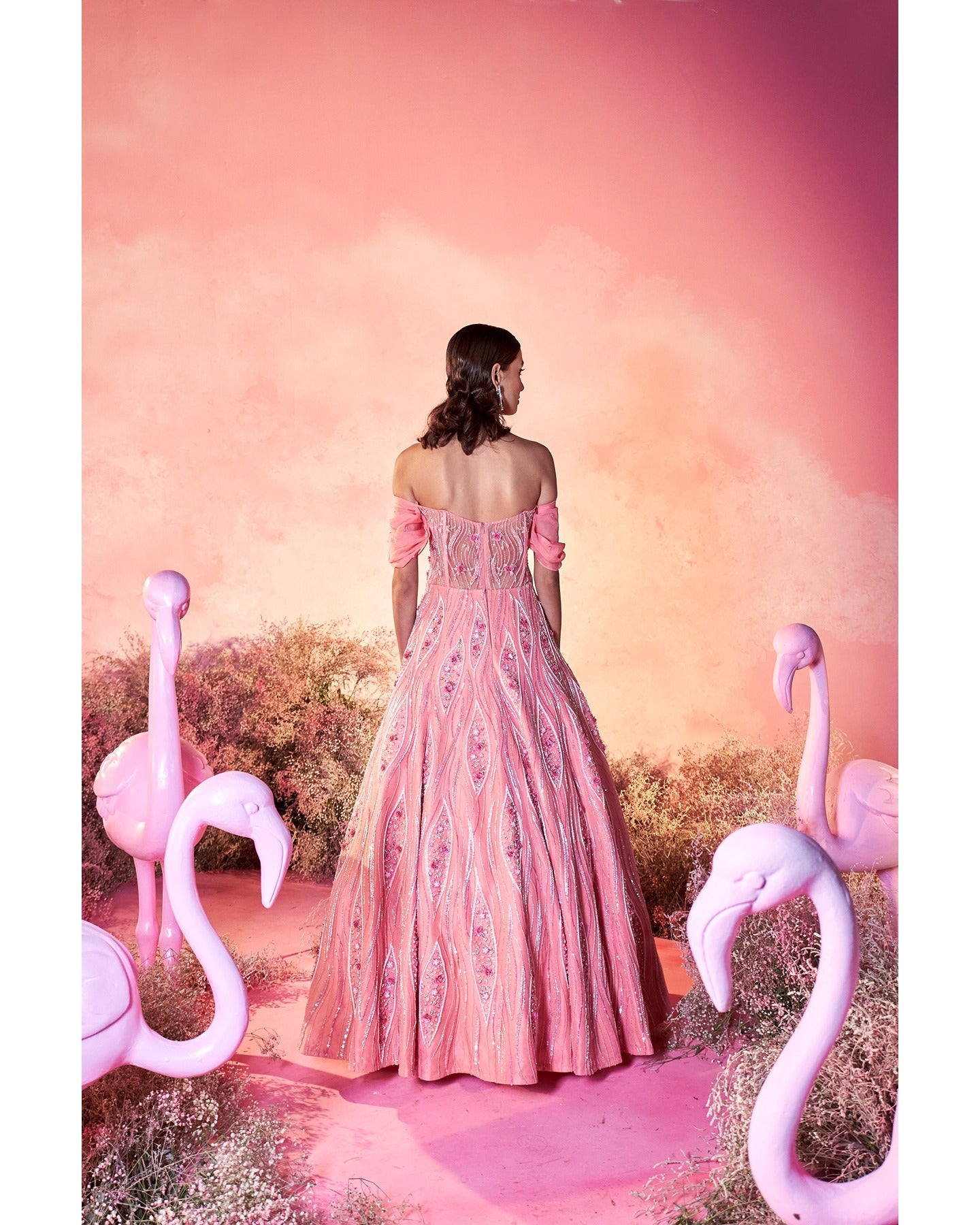 In the spotlight: Dazzling in bright pink, this hand-embroidered gown is a masterpiece of elegance and craftsmanship.