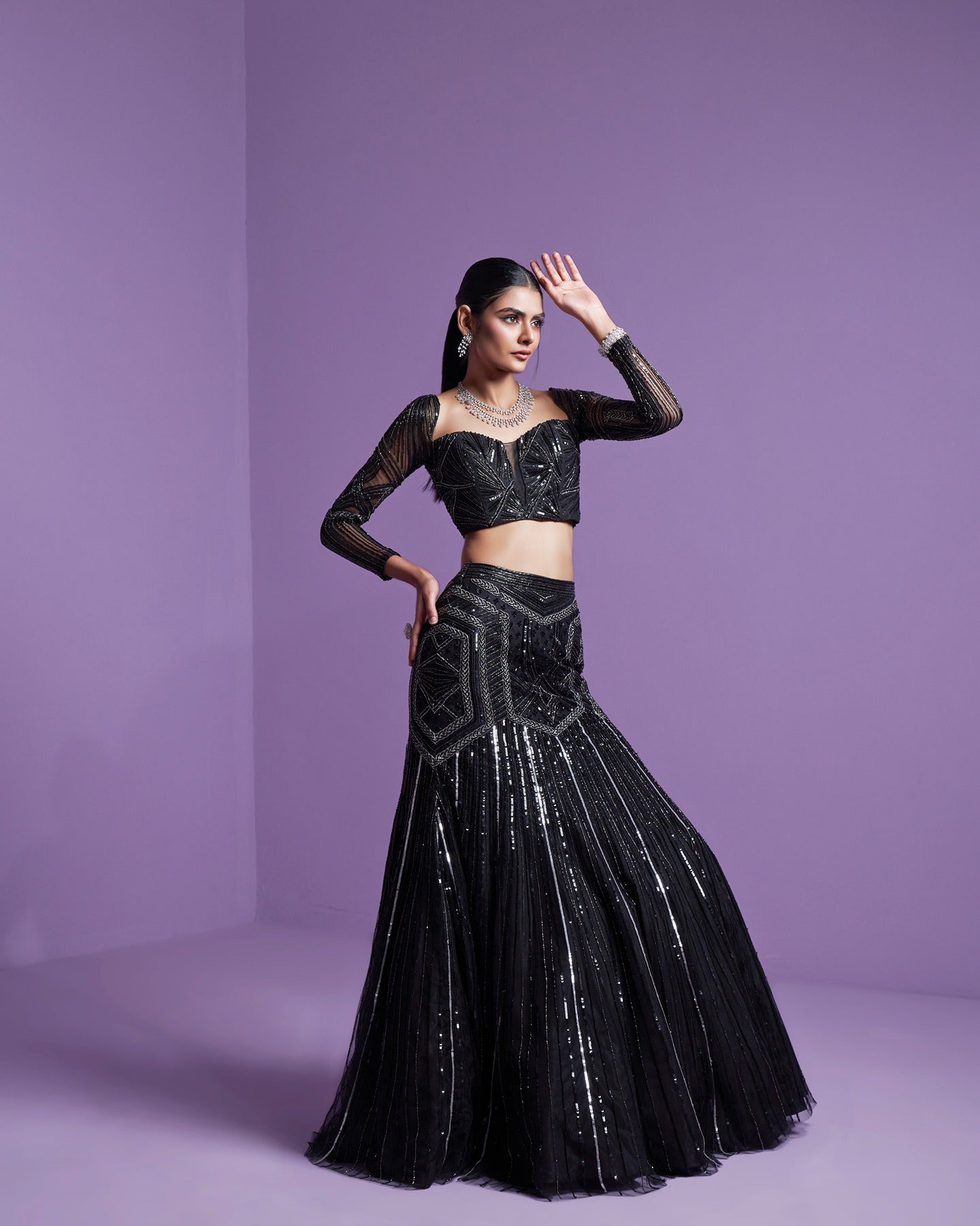 In the realm of elegance, black speaks volumes. Adorned in mystery, this black lehenga weaves a tale of timeless sophistication and enchanting allure. Embrace the dark glamour. 