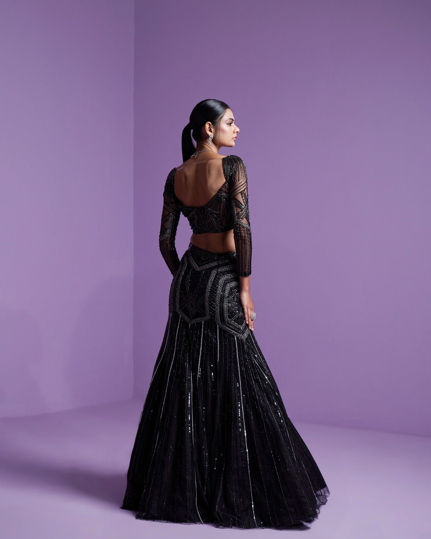 In the realm of elegance, black speaks volumes. Adorned in mystery, this black lehenga weaves a tale of timeless sophistication and enchanting allure. Embrace the dark glamour. 