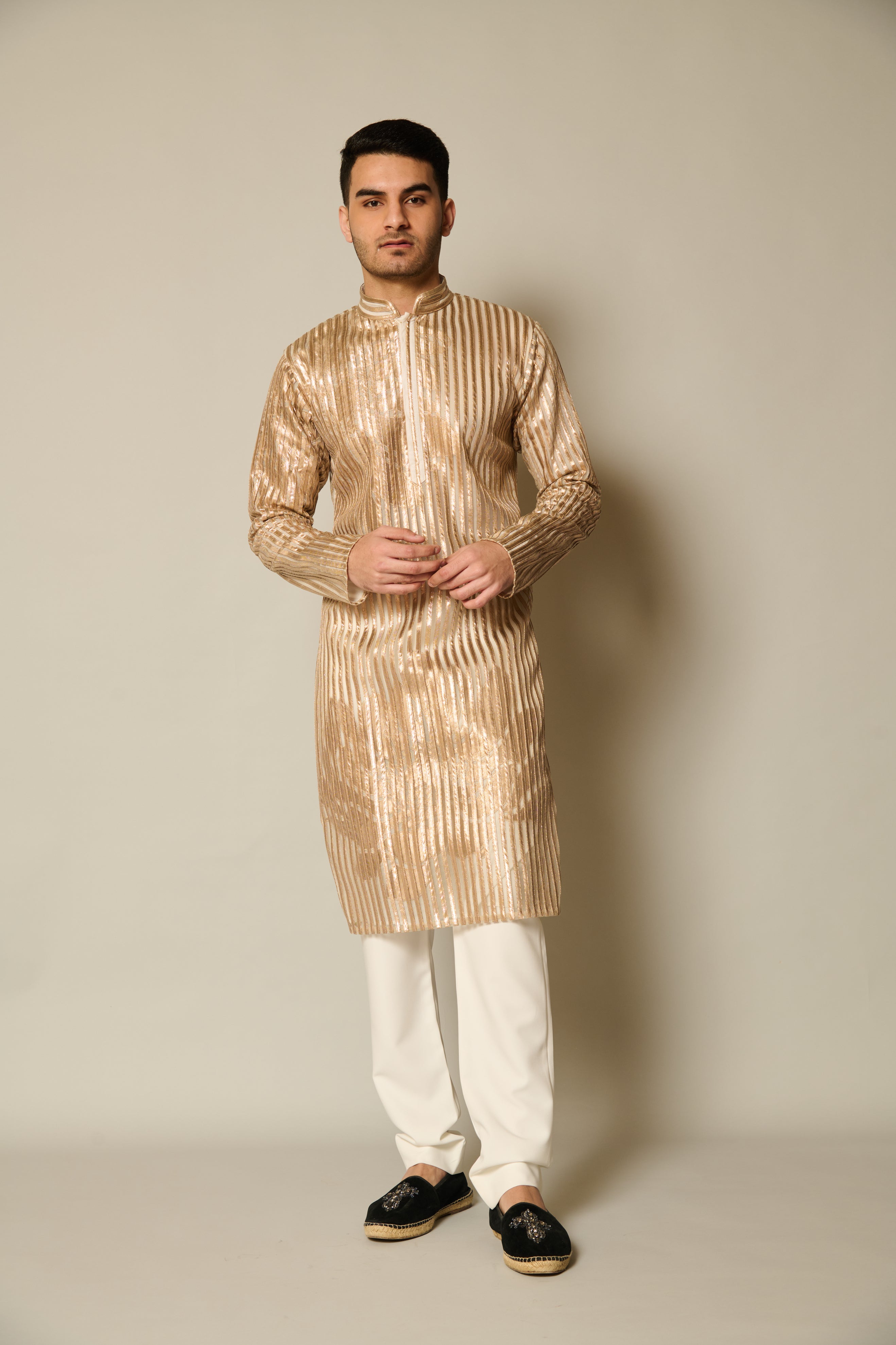 Elegant gold strip kurta featuring intricate gold floral applique and shadow work detailing