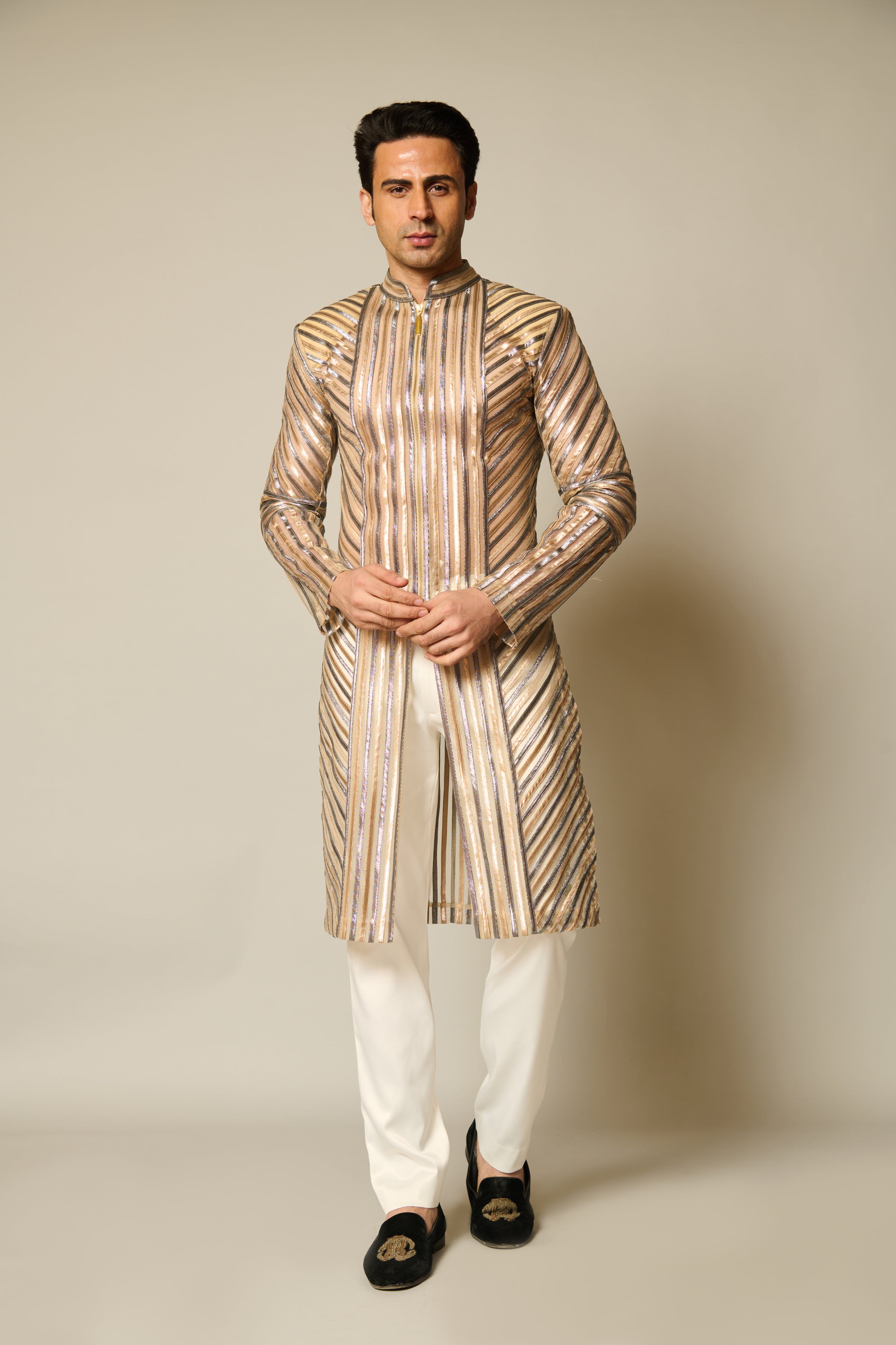 Close-up of sheer sherwani featuring intricate gold and gunmetal strip detailing, creating a sophisticated and contemporary look.