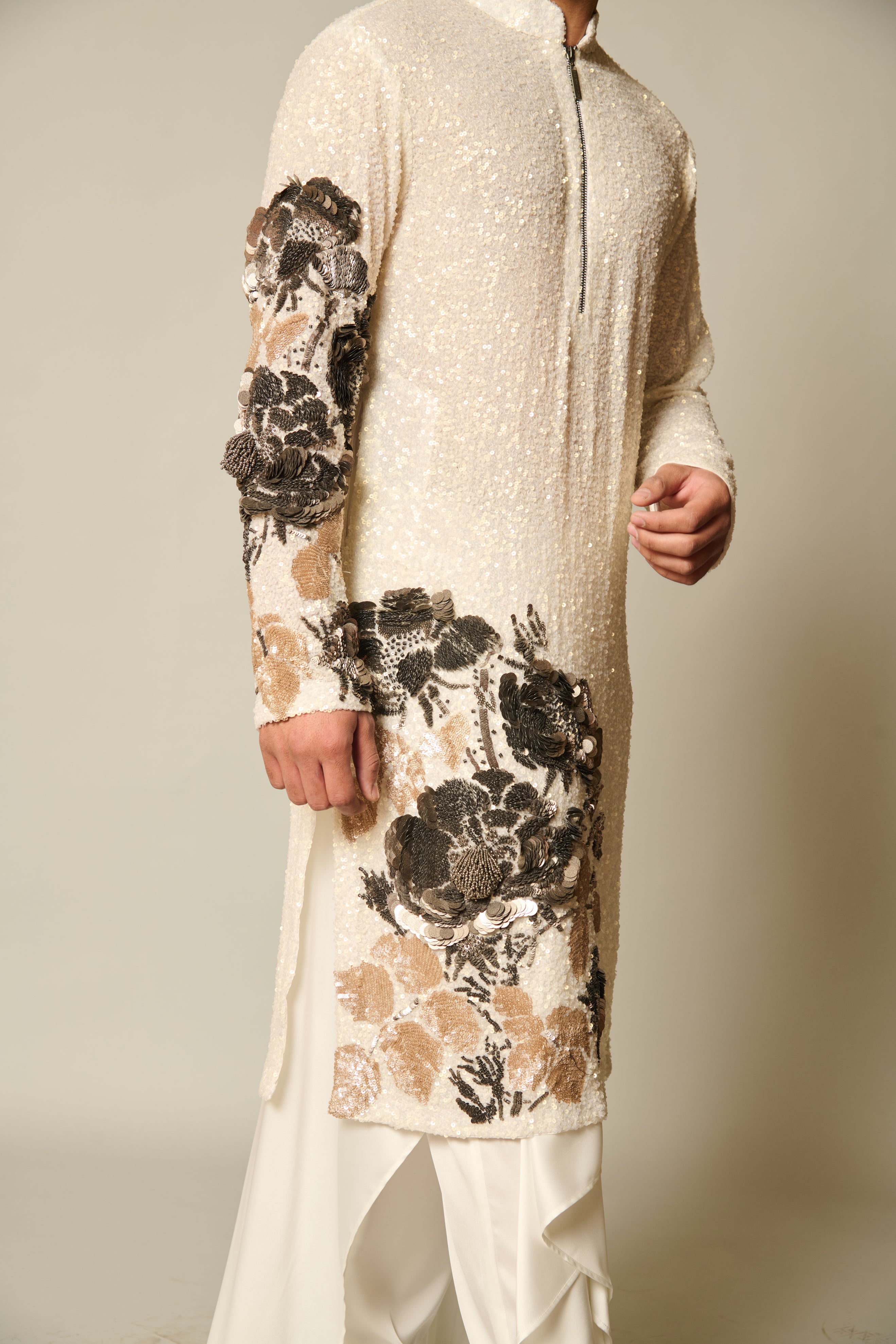 Chic ivory kurta with sequin floral embroidery and metallic 3D flowers, accompanied by ivory satin pants and a stylish draped skirt overlay