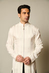 Elegant ivory striped satin kurta-sherwani paired with black and white satin flap pants