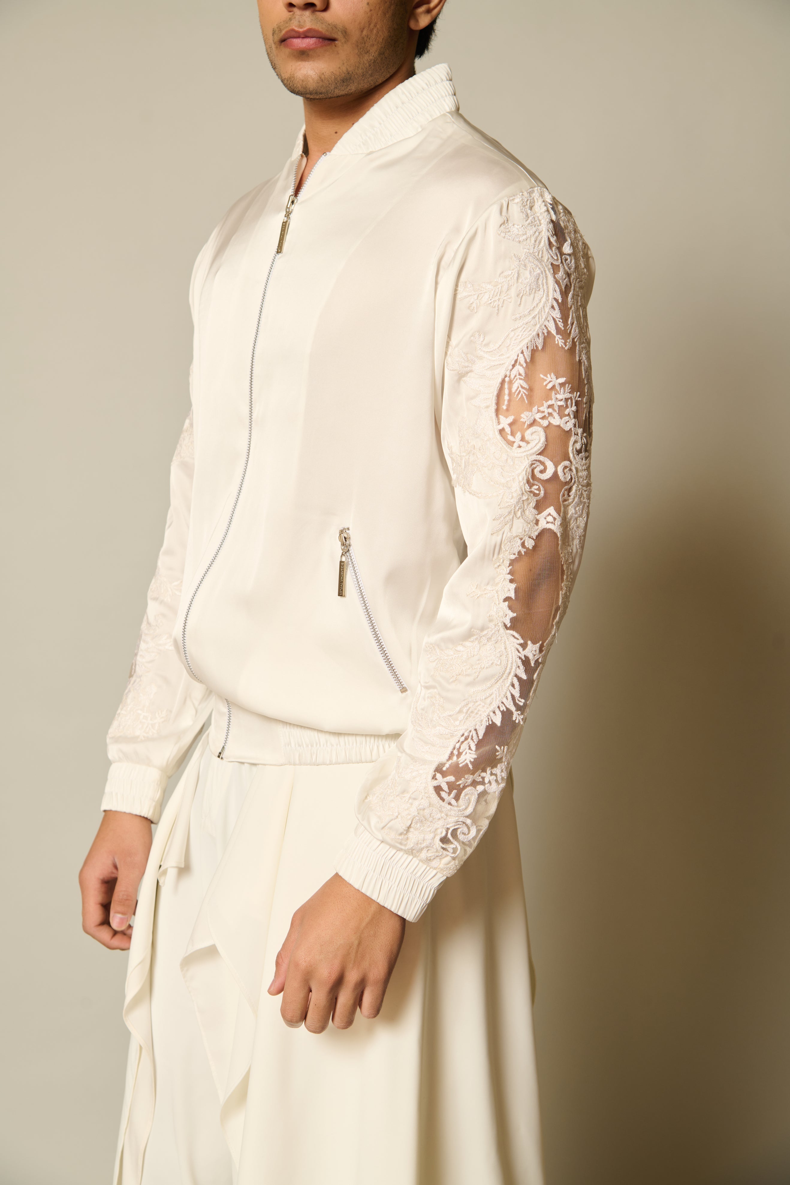 Sophisticated ivory satin bomber jacket with beautifully embroidered lace window sleeves