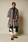 Elegant black microfiber kurta with a draped design, complemented by black and white flap dhoti pants