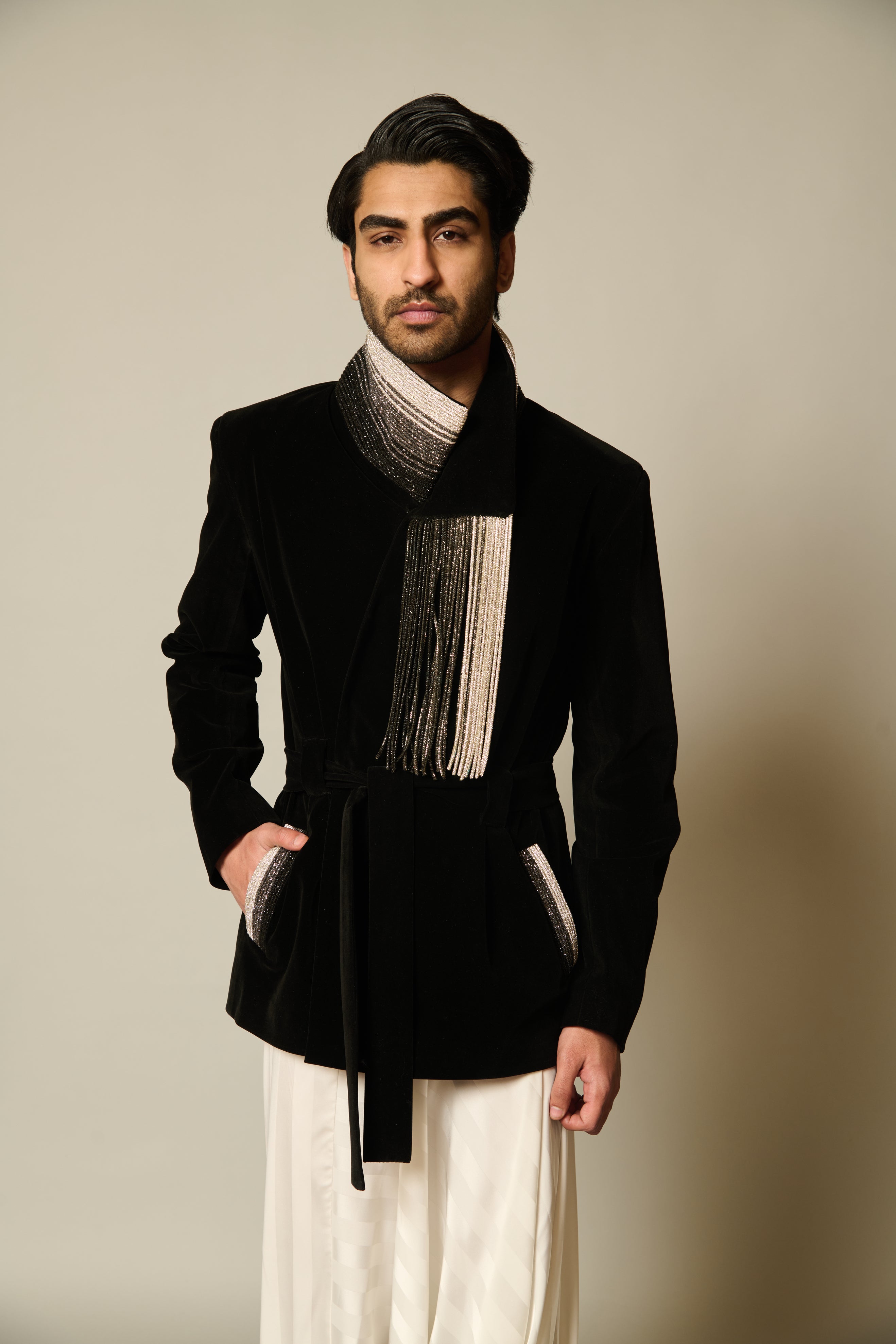 Luxurious black velvet safari jacket featuring a distinctive tritone crystal roped collar.