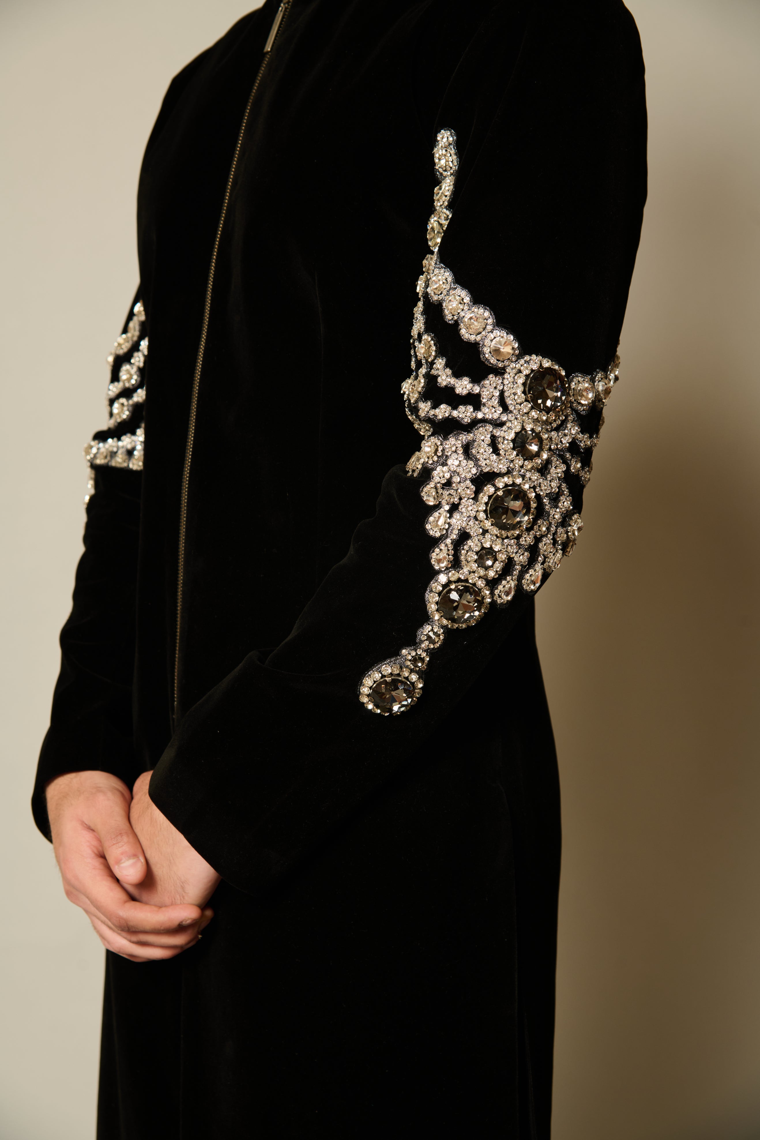 Side view of black velvet sherwani with detailed crystal embroidery on the sleeves, perfect for formal occasions.