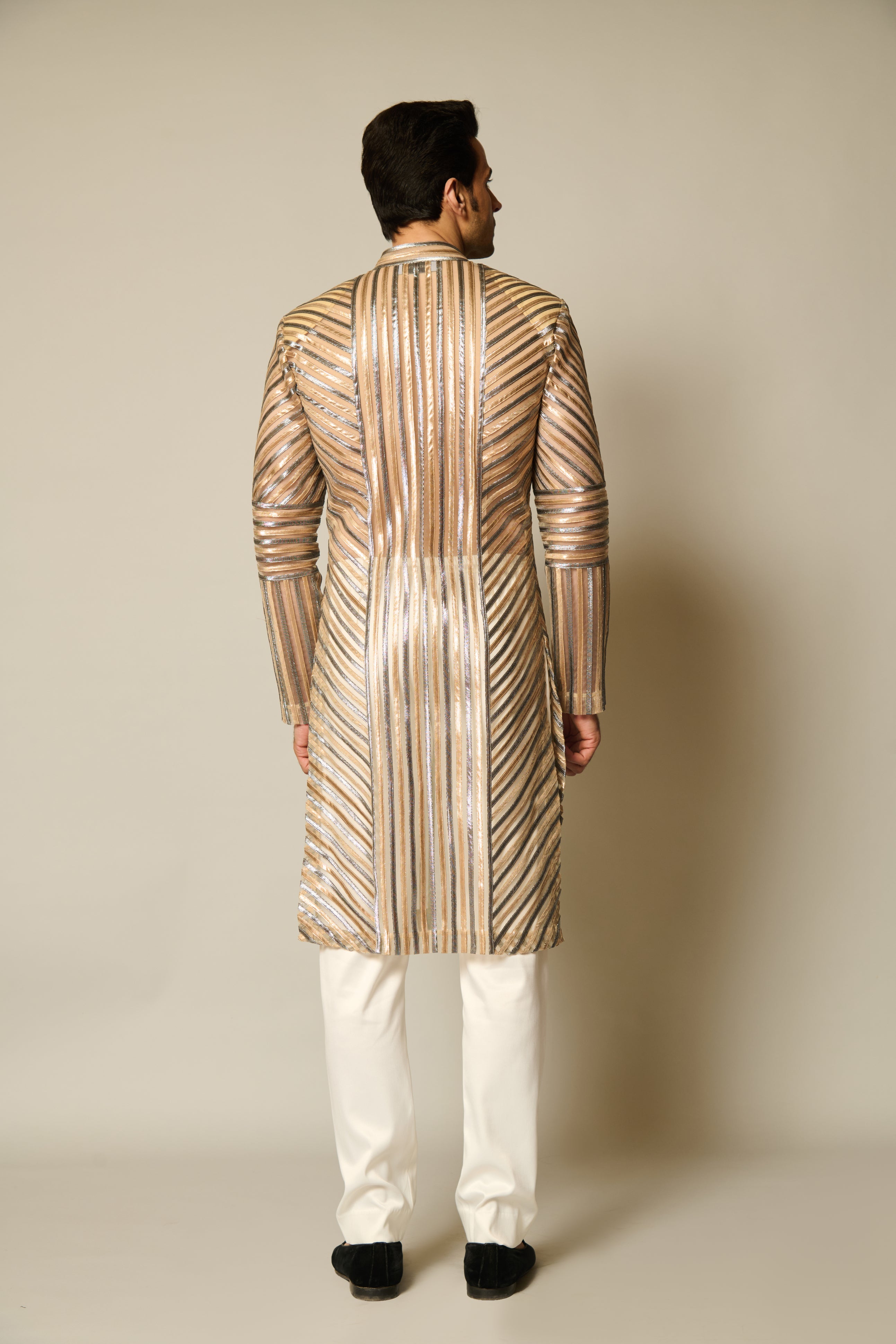 Sheer sherwani with gold and gunmetal strip work, combining modern elegance with traditional style.