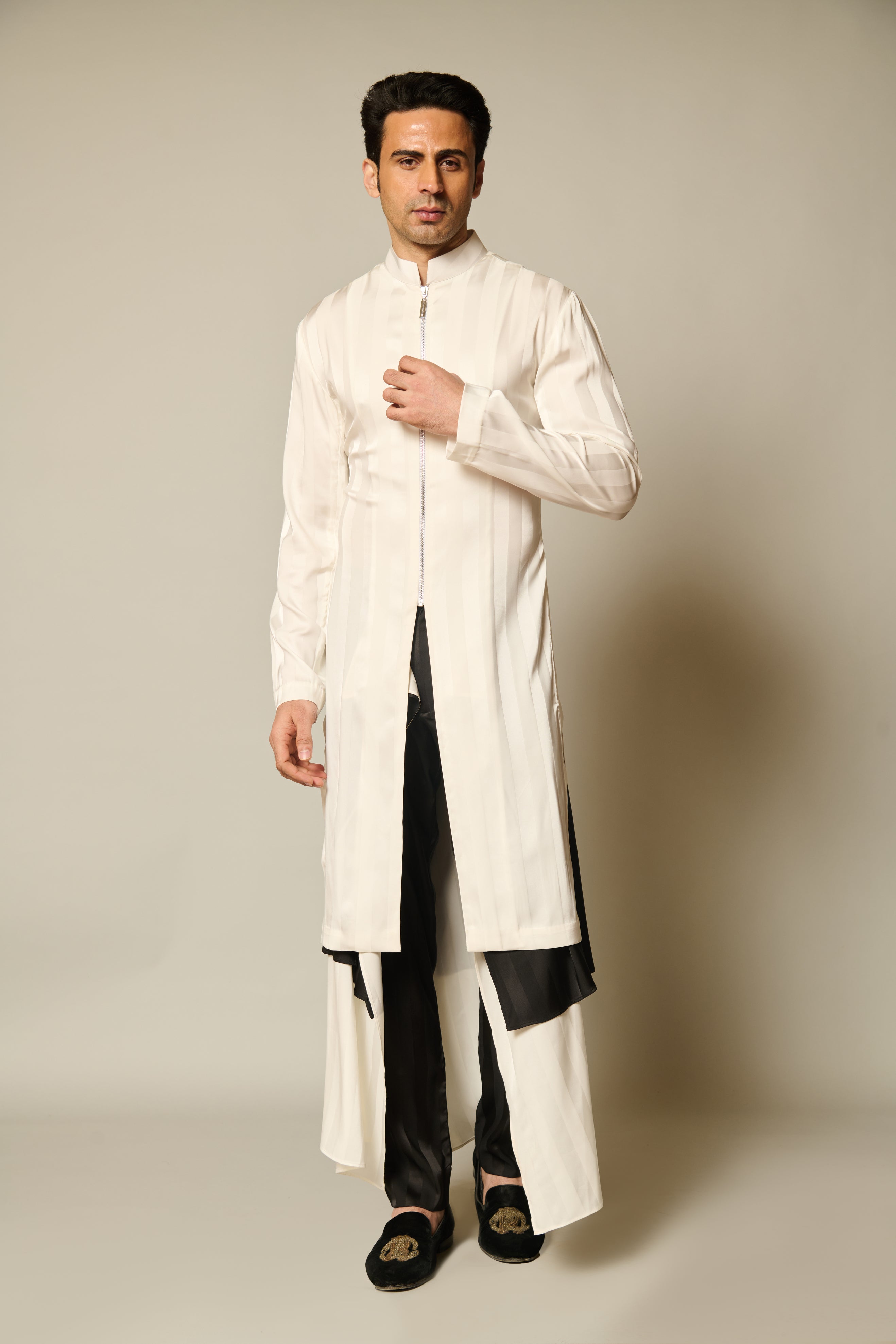 Chic ivory kurta-sherwani featuring striped satin and matching black and white satin flap pants