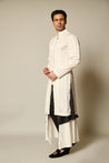 Stylish ivory satin kurta-sherwani with a striped design, enhanced by black and white satin flap pants