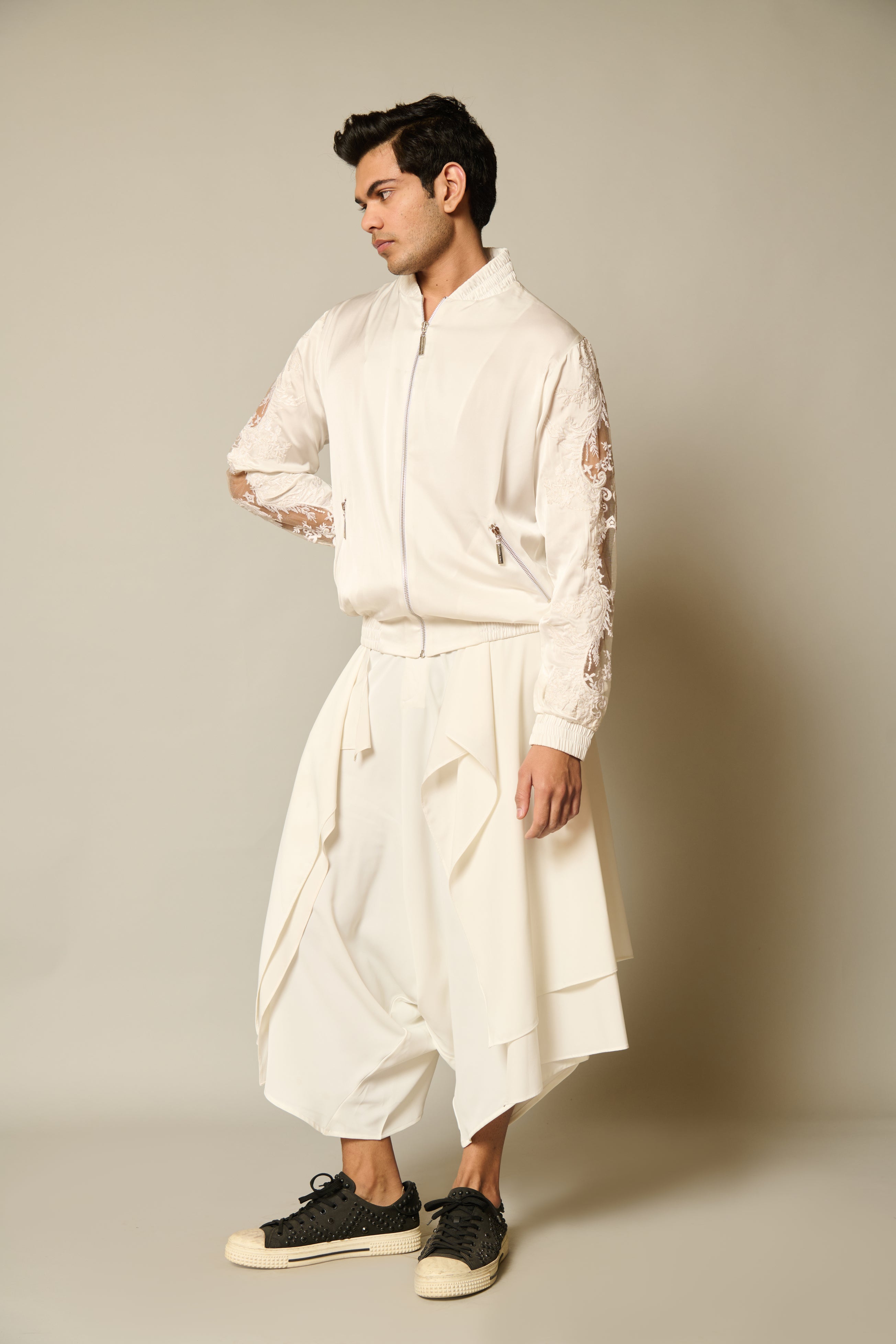 Modern ivory satin bomber jacket adorned with exquisite lace window embroidery on the sleeves.