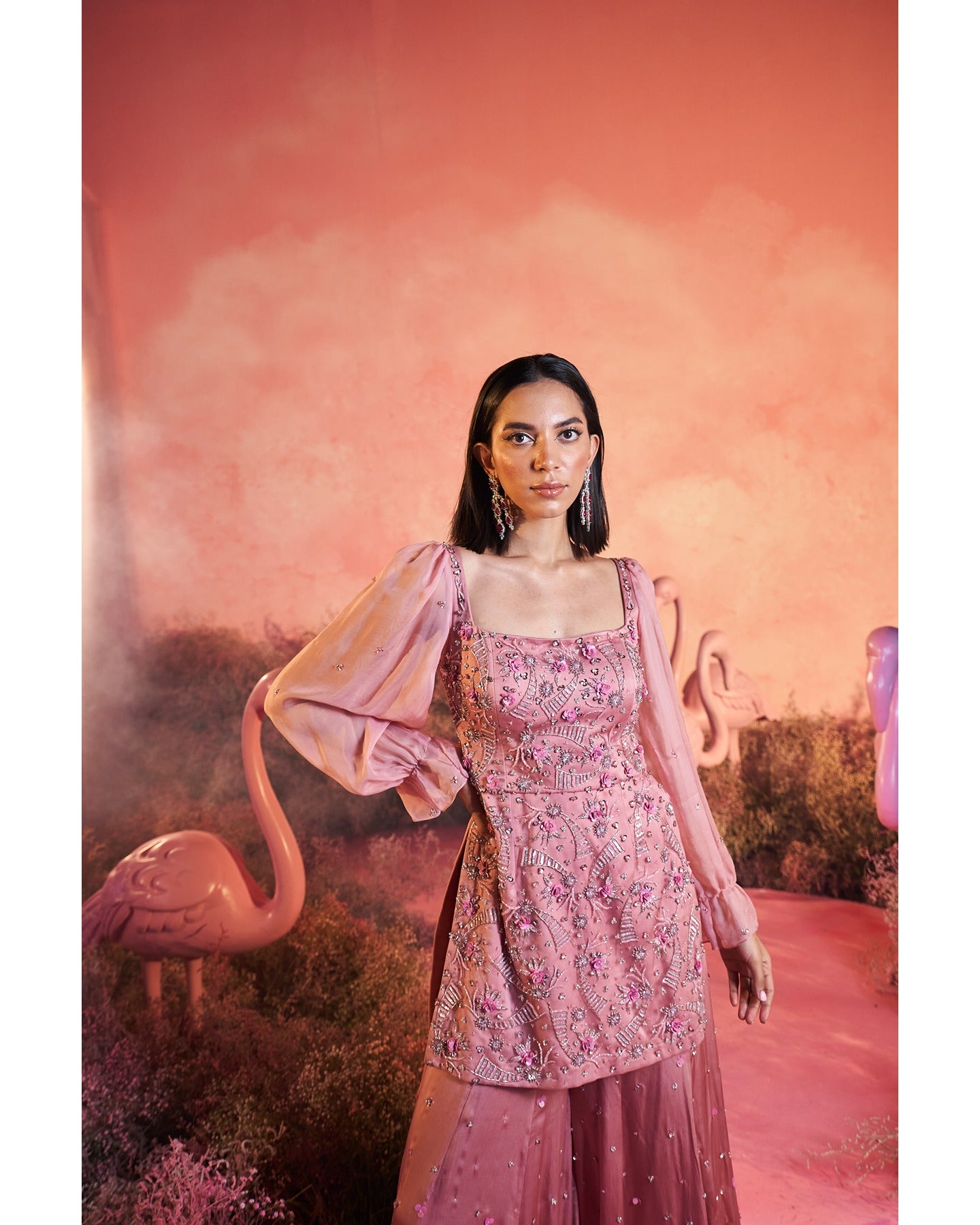 Pretty in Pink: A symphony of hand-embroidery graces this charming sharara set, weaving elegance into every stitch.