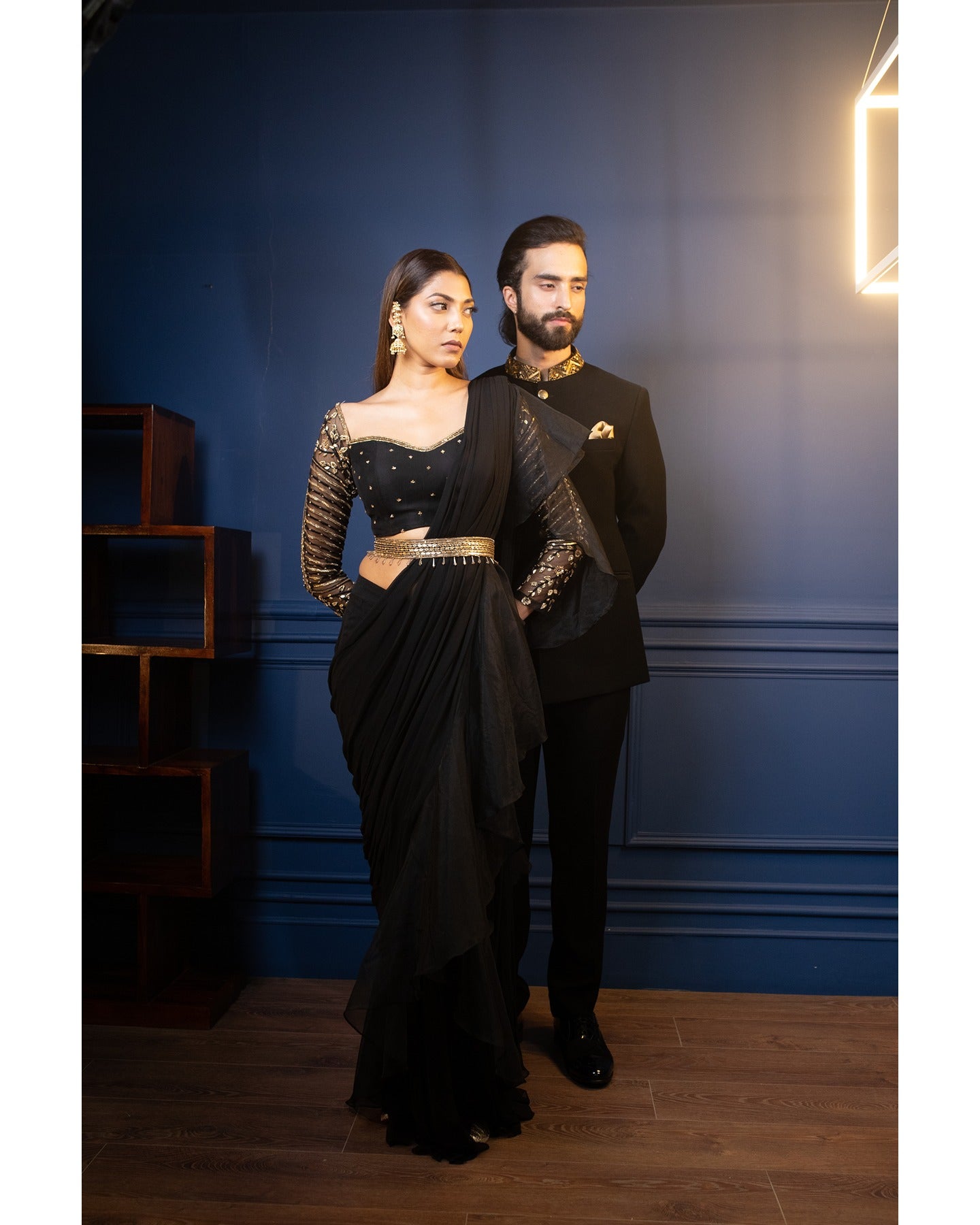 Draped in timeless elegance, this black saree captivates with its graceful allure.