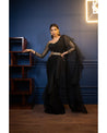 Draped in timeless elegance, this black saree captivates with its graceful allure.