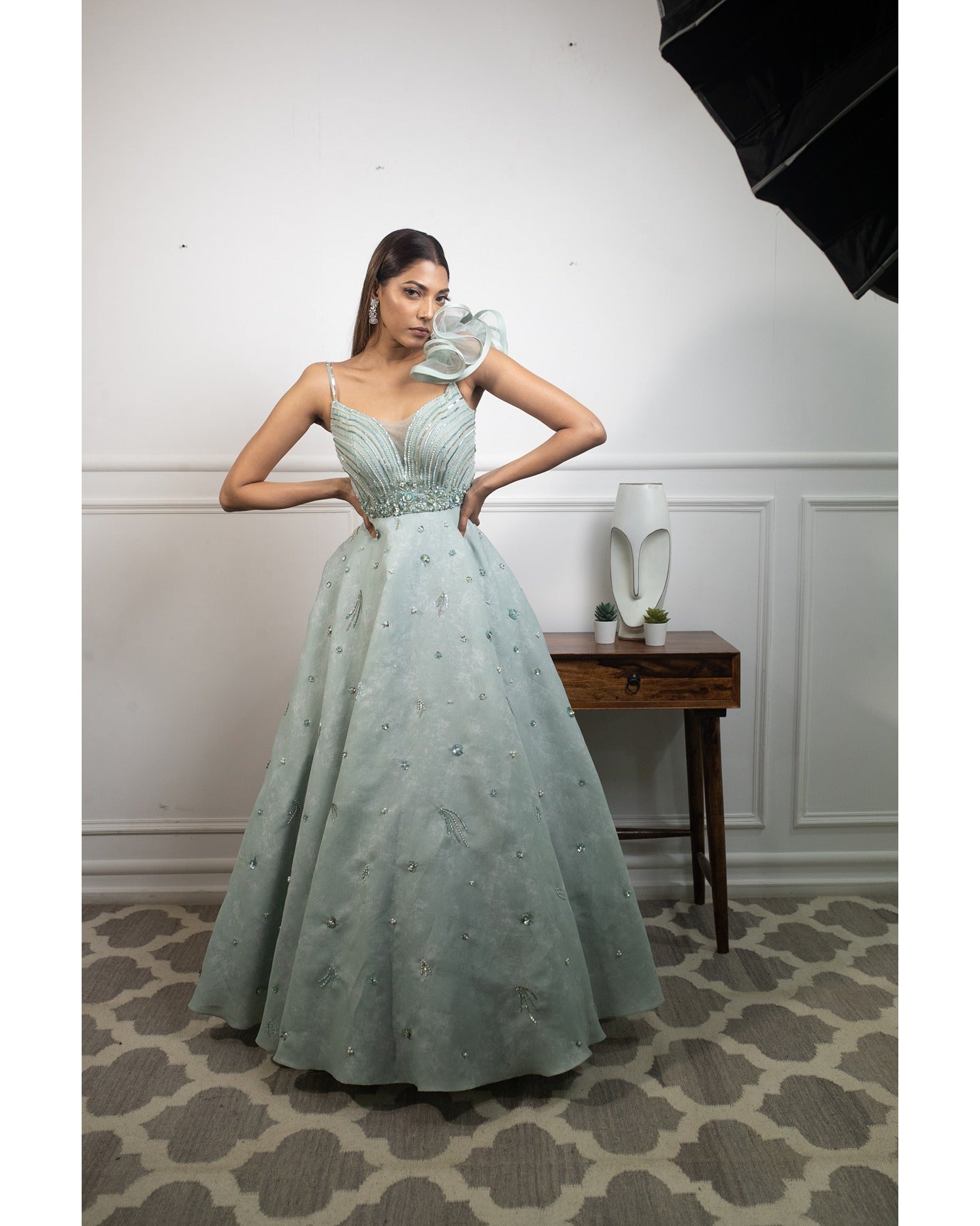 Drenched in the refreshing hues of mint blue, this gown is a breath of fresh elegance. 