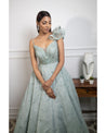 Drenched in the refreshing hues of mint blue, this gown is a breath of fresh elegance. 