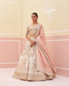 Timeless ivory raw silk lehenga set adorned with subtle gold accents"