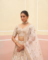 Graceful blush pink raw silk lehenga set featuring delicate beadwork