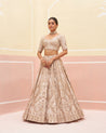 Exquisite blush pink raw silk lehenga set adorned with subtle embellishments