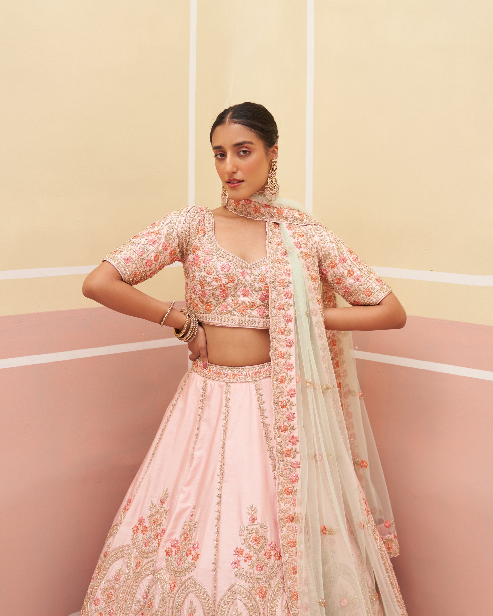 Chic pink raw silk lehenga set adorned with subtle embellishments