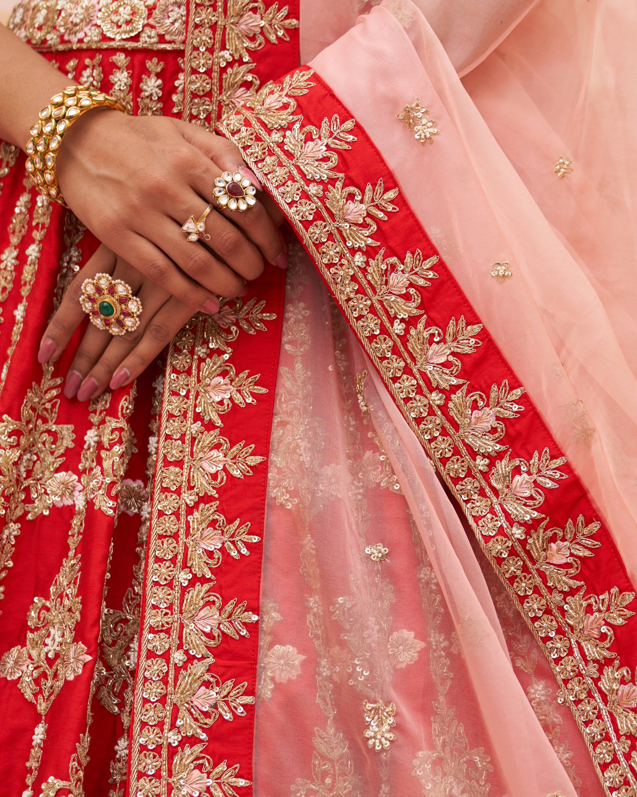 Opulent red raw silk lehenga set adorned with traditional motifs