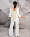 Draped in the understated charm of ivory, this blazer suit is a symphony of elegance. 