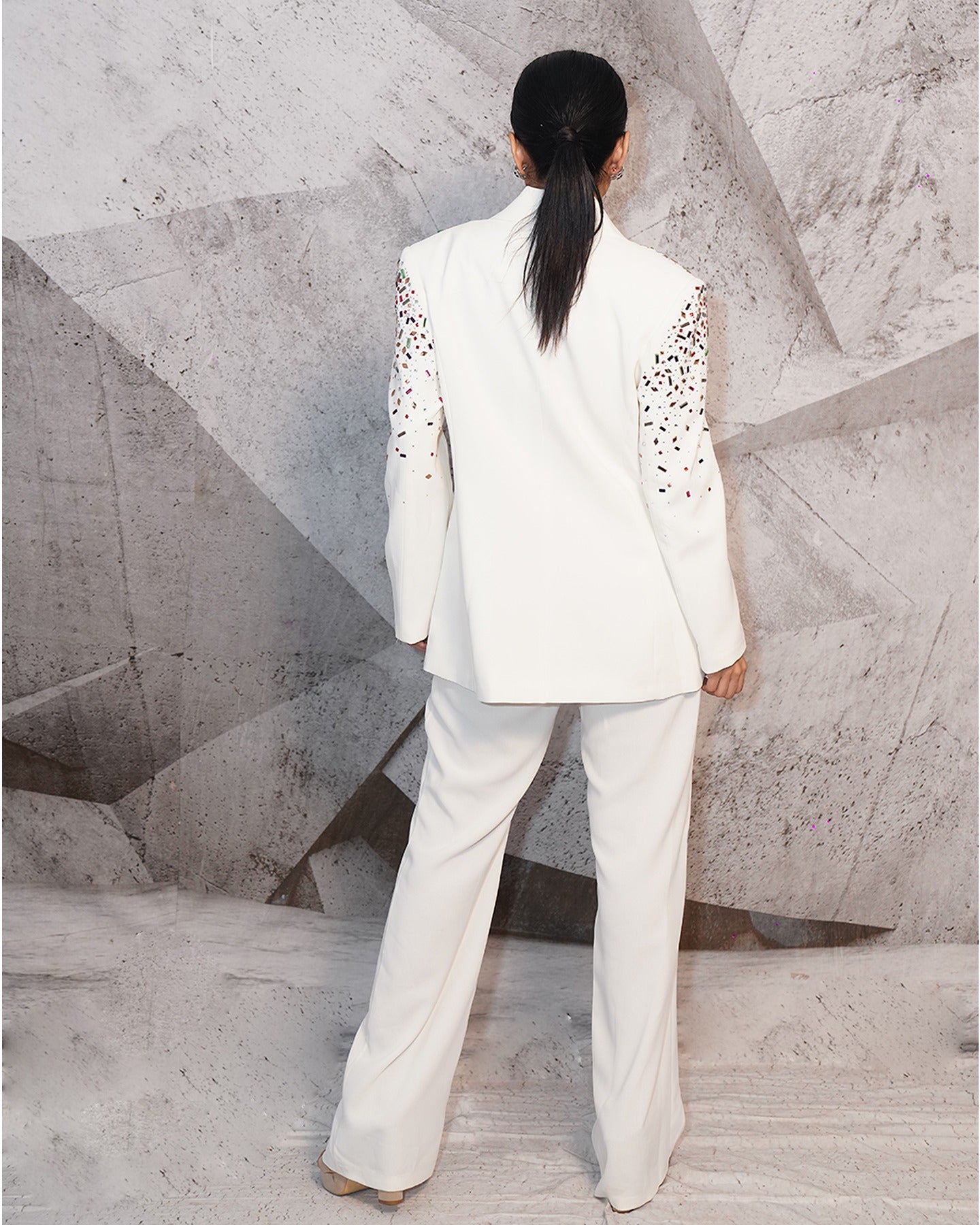 Draped in the pristine elegance of white, this blazer suit exudes timeless sophistication. 