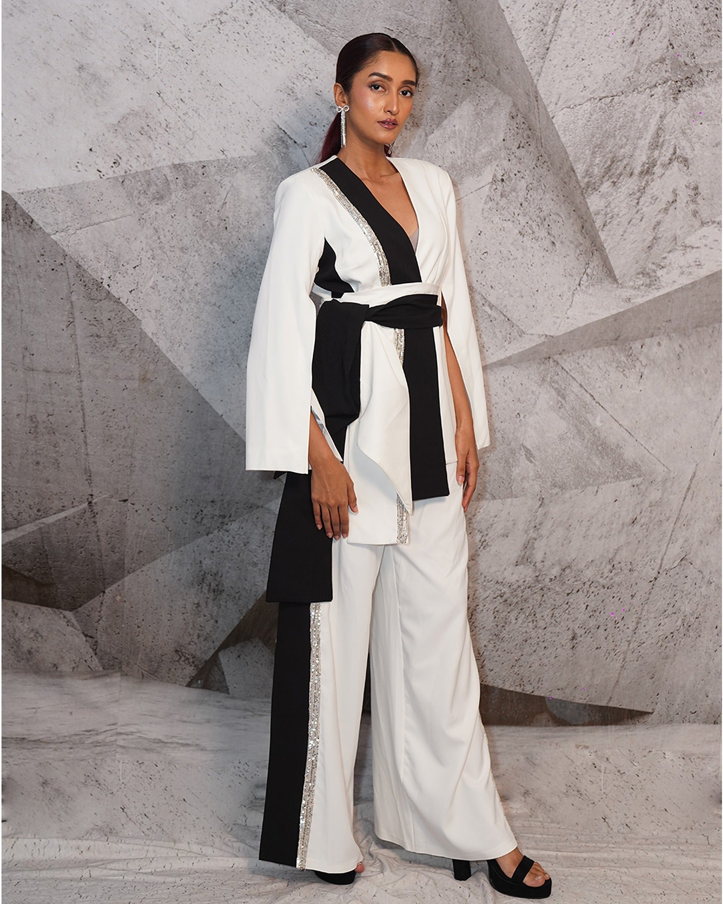 Where the timeless allure of white meets the bold sophistication of black, elegance takes center stage in this blazer suit ensemble.