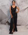 Draped in the midnight elegance of black, this gown speaks volumes with its glittering sequins and a touch of 3D feathers.