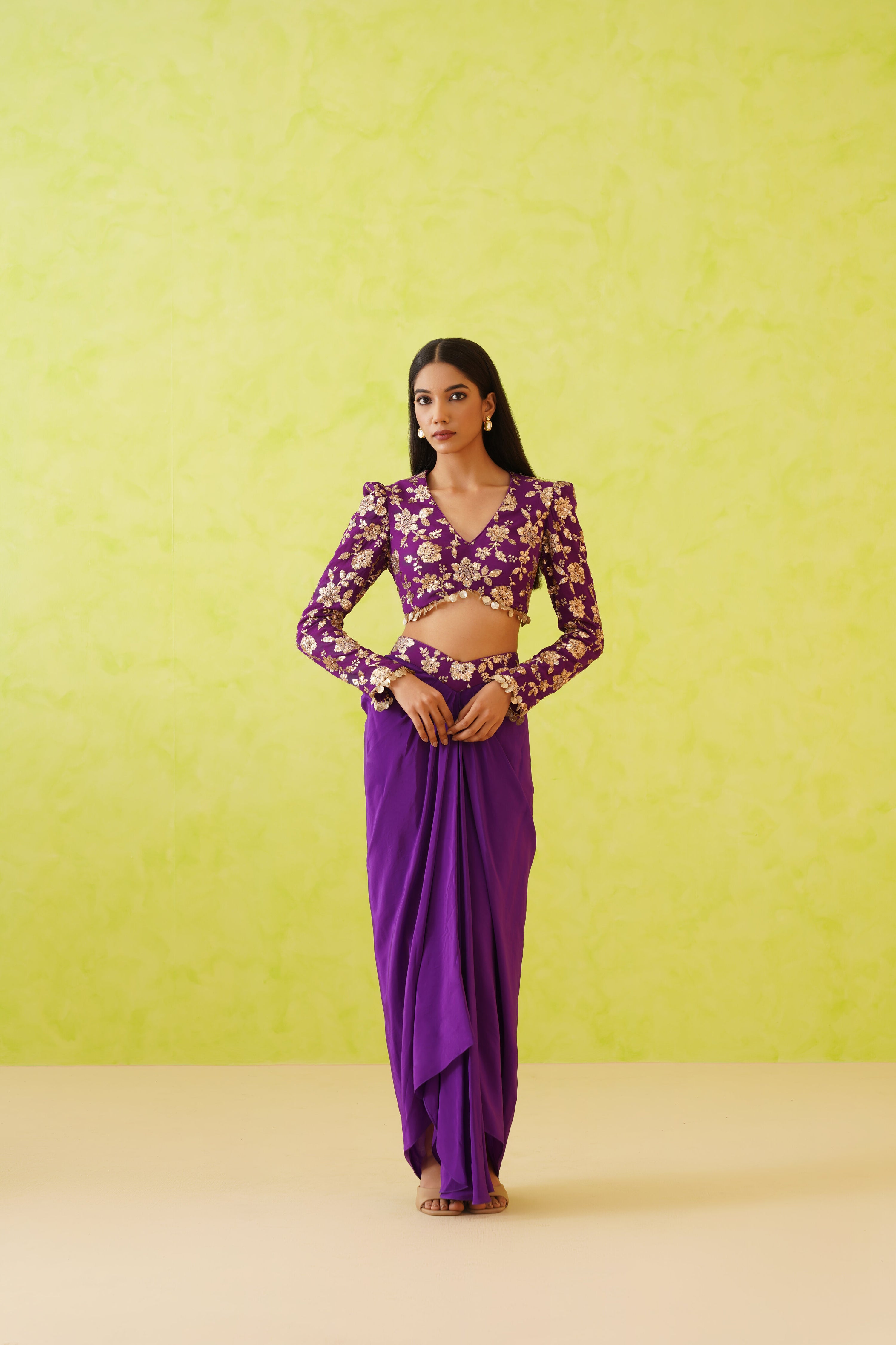 A vibrant purple dhoti set crafted from rich crepe fabric, featuring a flowy dhoti and an embellished blouse, perfect for festive celebrations.