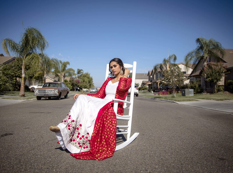 White lehenga set with a red jacket