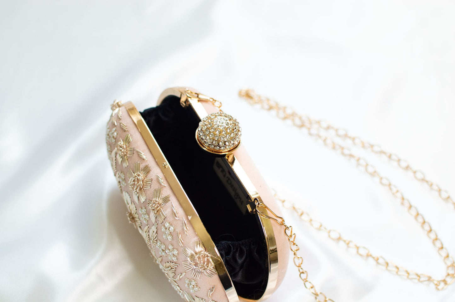 Peach clutch purse with stone studded closure & gold strap chains