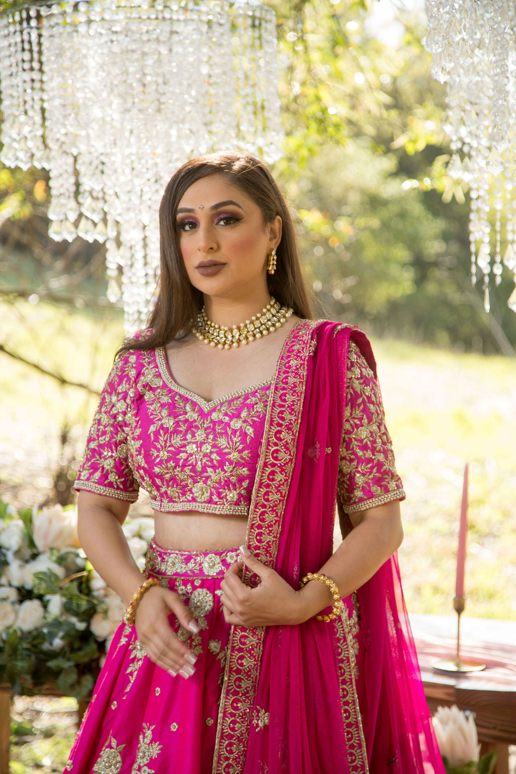 Photo of Bride wearing light pink lehenga and green contrasting jewellery