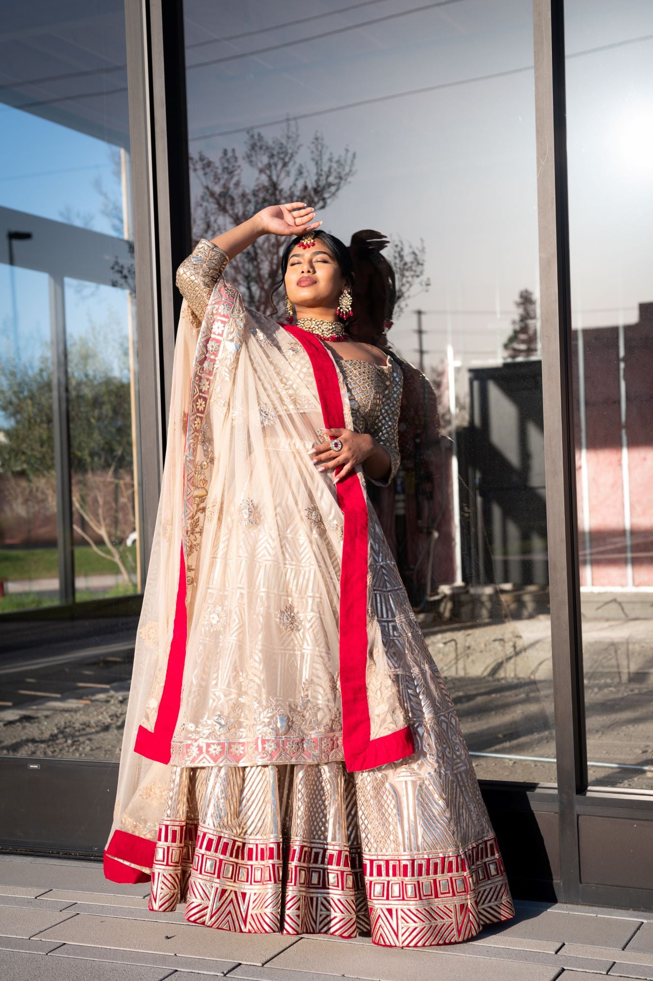 RED CLASSIC BRIDAL LEHENGA SET WITH PATTERNED ZARI EMBROIDERY AND A HALTER  STYLE BLOUSE PAIRED WITH A MATCHING DUPATTA AND ALL OVER SILVER AND  SEQUINNED EMBELLISHMENTS. - Seasons India